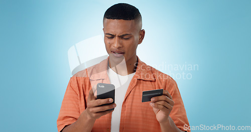 Image of Man, credit card and phone in studio, frustrated face or confused with thinking, fintech and blue background. Person, smartphone and online shopping with glitch, payment decline and fail with banking