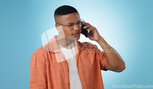 Image of Man, confused and cellphone in studio for call connection, bad signal or communication. Male person, mobile and internet chat social media or conversation web talking, blue background as mockup space