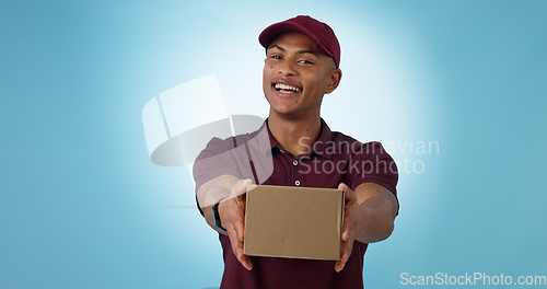 Image of Portrait, happy man and courier with delivery in studio for mock up on blue background in Cape Town. Male model, smile and excited for logistics, shipping or distribution of package, parcel or order