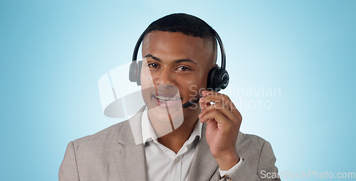Image of Call center, man and portrait in studio for customer service, CRM questions and IT support on blue background. Face of telemarketing salesman, virtual consultant and microphone for telecom advisory