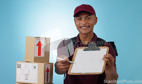 Image of Delivery man, boxes and document for signature, distribution or courier service checklist on a blue background. Portrait of logistics worker with package and receipt or clipboard paperwork in studio