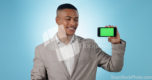 Image of Business man, phone green screen and presentation, advertising information or trading software in studio. Happy, professional and trader with mobile app or space, tracking markers and blue background