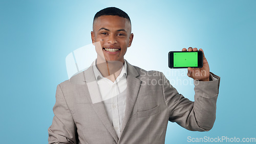 Image of Business man, phone green screen and portrait for presentation, advertising information or trading software in studio. Happy, face and young trader on mobile app, tracking markers and blue background