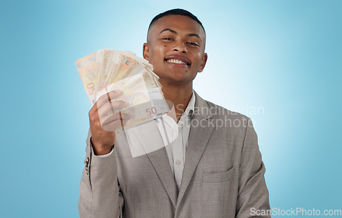 Image of Business man, winner and money fan for success, bonus and winning in a competition, loan or cashback in studio. Portrait of young worker with cash, reward or financial savings on a blue background