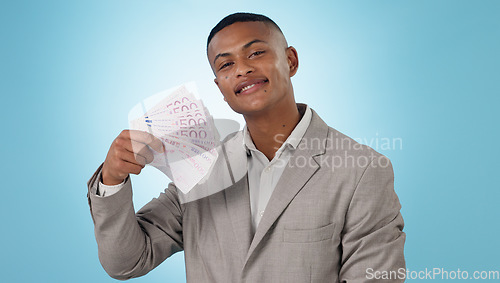Image of Business man, winning and money fan for success, bonus and lottery prize, stock market profit or cashback in studio. Portrait of winner or trader cash and financial achievement on a blue background