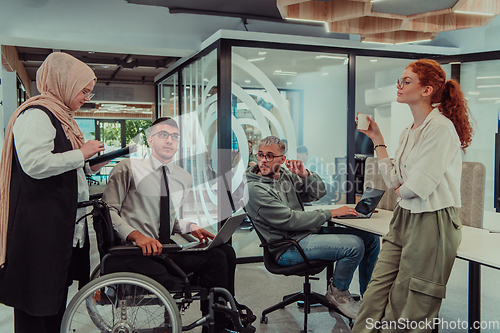 Image of Young group of business people brainstorming together in a startup space, discussing business projects, investments, and solving challenges.