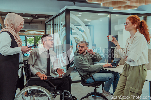 Image of Young group of business people brainstorming together in a startup space, discussing business projects, investments, and solving challenges.