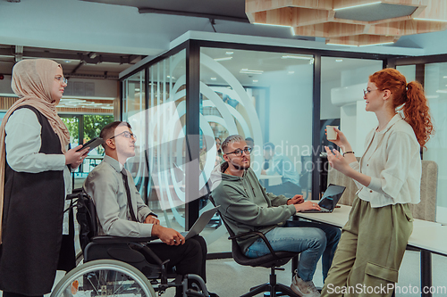 Image of Young group of business people brainstorming together in a startup space, discussing business projects, investments, and solving challenges.