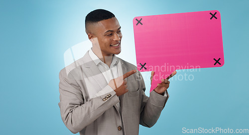 Image of Business man, speech bubble and presentation of chat poster, social media quote or communication in studio. Young worker pointing to FAQ mockup, career forum and tracking markers on a blue background