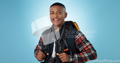 Image of Man, portrait or backpack in studio or adventure hiking, mockup space on blue background. Black person, face or smile for camper explorer or fitness journey for discover, vacation or travel trekking