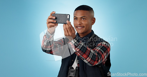 Image of Hiking, man and cellphone with social media, photography and profile picture on a studio background. Person, traveller and model with a smartphone, travel and post with blog, tourism and adventure