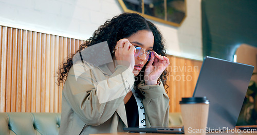 Image of Laptop, reading glasses and coffee shop woman check internet, web or online research for freelance project, data or report. Customer analysis of hospitality review, restaurant info or diner article