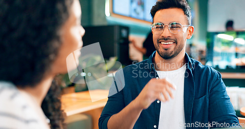 Image of Happy man, glasses and smile on date in coffee shop for food, lunch or snack. Mexican person, laugh and funny joke with girlfriend in restaurant, bistro or cafe for bond, together and relationship