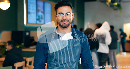 Image of Portrait, man or employee with smile in coffee shop for small business, management or work. Male waiter, glasses and confidence in apron by entrance for welcome, customer and restaurant for service