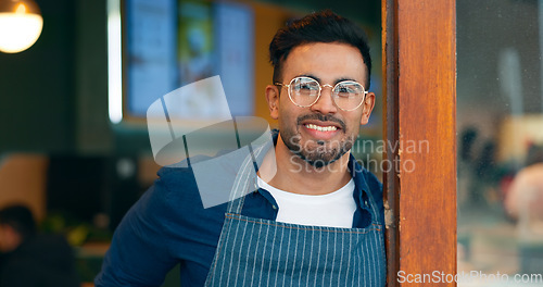 Image of Portrait, entrance and happy man, restaurant business owner or coffee shop manager smile for cafeteria service. Hospitality, management and confident barista, waiter or server leaning on cafe door