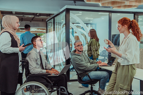 Image of Young group of business people brainstorming together in a startup space, discussing business projects, investments, and solving challenges.