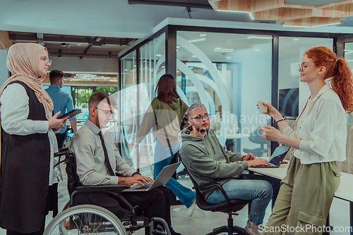 Image of Young group of business people brainstorming together in a startup space, discussing business projects, investments, and solving challenges.