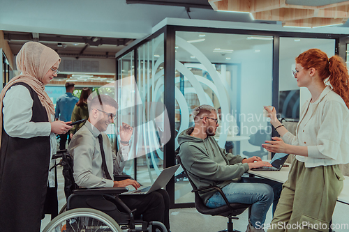 Image of Young group of business people brainstorming together in a startup space, discussing business projects, investments, and solving challenges.