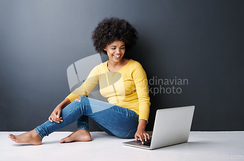 Image of Online, remote work and black woman with laptop, studio and happiness on floor with education mockup. Computer, research and college student typing on keyboard for elearning, project and studying