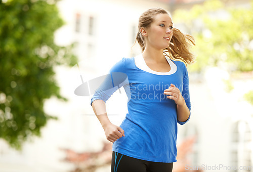 Image of Neighborhood, running and woman with fitness in exercise or outdoor cardio workout in urban, city or town. Healthy, runner or training with energy, motivation and goals for wellness in summer or park