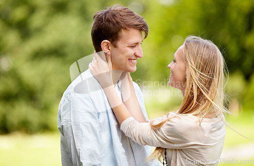 Image of Park, happy and couple smile, eye contact and in nature, natural garden or romance date for freedom, love or bond. Partner, spring and relax man, woman or people together for care, support or embrace