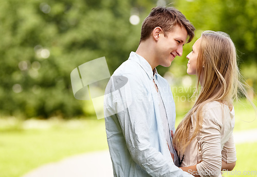 Image of Park, eye contact and happy couple hug, love and bonding in outdoor nature, green garden or romantic date. Happiness, wellness and spring man, woman or marriage people embrace for relationship care