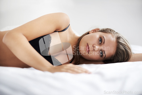 Image of Bed, relax and portrait of woman in lingerie in her home resting, peaceful and chilling on the weekend. Underwear, face and female person lying in a bedroom with confidence, comfortable or waking up