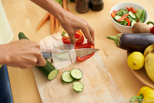 Image of Closeup, hands and cutting with vegetables, nutrition and plant based diet in a kitchen. Person, home and cooking health food, lunch and vegan meal with variety, vitality and weight loss with knife