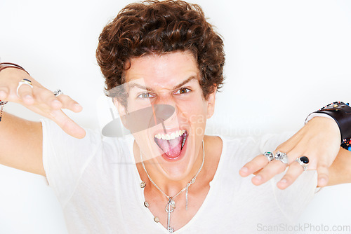 Image of Portrait, energy and crazy with a man in studio isolated on a white background for the expression of emotion. Face, fashion and freedom with an edgy young model looking wild or fierce rockstar style