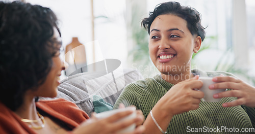 Image of Lesbian couple, coffee and women talking on sofa in home for bonding, connection and relax together. Love, lgbtq and happy people drinking tea in living room for chatting, discussion and conversation