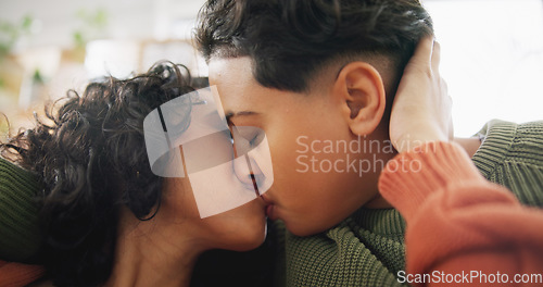 Image of Love, home face and lesbian couple kiss, intimate and care for marriage, non binary or transgender partner on lounge sofa. LGBT, trust and same sex people bonding, support and enjoy time together