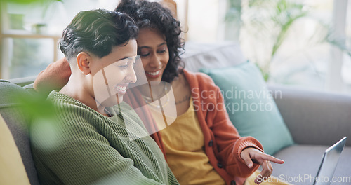 Image of LGBT, laptop and talking lesbian couple, gay women or queer partner discussion on online shopping choice. Lounge sofa, communication and home conversation of homosexual people chat about omnichannel