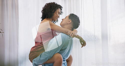 Image of Love, carry and lesbian couple kiss, homosexual women hug or queer girlfriend bond, desire and intimate in Colombia home. LGBT, embrace and transgender people with marriage partner in honeymoon hotel