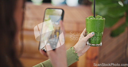 Image of Phone screen, photography and green juice for diet, woman or glass in cafe for social network app. Influencer girl, smartphone and smoothie in post, update and web blog for nutrition, detox or health