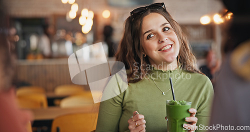 Image of Girl friends, talk and smoothie in cafe, green drink and happy for health, nutrition and juice with smile. Gen z woman, milkshake or diet with group, students and chat in restaurant, diner and cafe