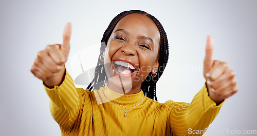 Image of Thumbs up, excited black woman and portrait in studio for success, winning deal and achievement on white background. Happy model, emoji and celebrate feedback, voting yes and thank you for excellence
