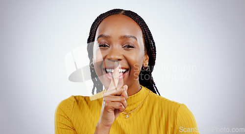 Image of Secret, portrait and black woman with finger on lips in studio for privacy, news or announcement on grey background. Gossip, whisper and face of happy female model with confidential, hand or emoji