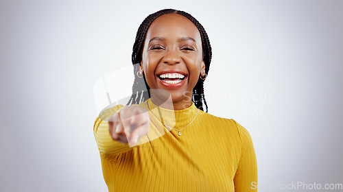 Image of Happy, portrait and black woman with hand pointing at you in studio for choice, vote or decision on grey background. Recruitment, opportunity and face of female model with emoji finger for job offer