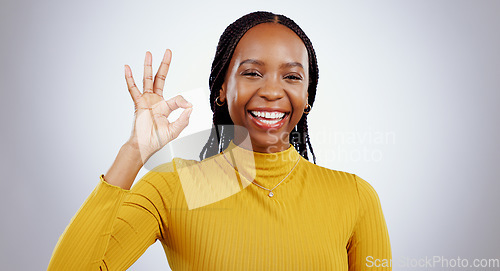 Image of Portrait, smile and black woman with perfect hand in studio for feedback, support or motivation on grey background. Ok, emoji and face of lady model with vote success, thank you or review excellence