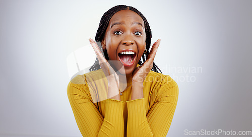 Image of Wow, news and hands on face of black woman in studio happy with competition, prize or bonus on grey background. Surprise, omg or portrait of African lady winner with mind blown emoji or lotto results