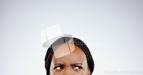 Image of Thinking, face and eyes of confused black woman with doubt, questions or remember idea in white background. Mockup, space and person frustrated with a memory, choice or planning a decision in studio