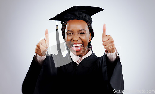 Image of Graduation cap, woman and thumbs up for study success, celebration and education, learning or college in studio. Portrait of excited African graduate or student with like emoji on a white background