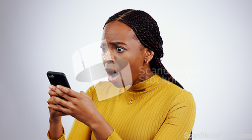 Image of Woman, reading phone and shocked for news, social media and online error or mistake on a white background. African person confused, surprise and stress on mobile for scam or notification in studio