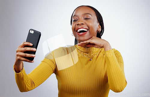 Image of Studio, happy or black woman taking selfie on social media with confidence, post or smile online. African lady, memory or face of influencer taking a photograph, vlog or picture on grey background