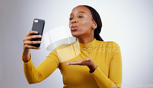 Image of Studio, kiss or black woman taking selfie on social media with confidence, post or smile online. African lady, memory or beauty influencer taking a photograph, vlog or picture on grey background