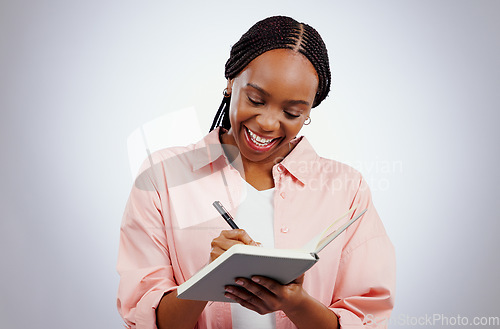 Image of Happy woman, notebook and writing ideas, planning or creative solution for studying, college or education goals in studio. African student with book reminder or notes for learning on white background