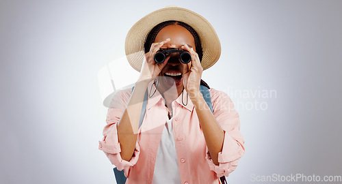 Image of Woman, binocular or smile in studio for travel, hiking or sightseeing with backpack on gray background. Black person, telescope lens or happiness for search, adventure and experience on mock up space