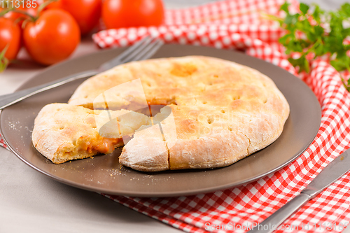 Image of Pizza calzone on wooden background