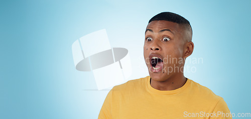 Image of Wow, surprise and shocked man in studio with news, information or promotion on blue background. Omg, emoji and face of male model with unexpected announcement, gossip or confused by secret giveaway