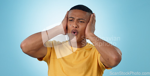 Image of Fail, mistake and hands on face of man in studio with disaster, news or oops gesture on blue background. Crisis, emoji and male model with regret, fear or trauma, body language or conflict anxiety